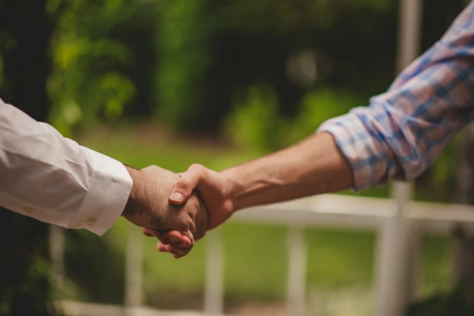 2 persons shaking hands symbolizing partnership- for resale of our artworks for your local art gallery, shop etc enabling our artists to expand their coverage and manifold their incomes. 