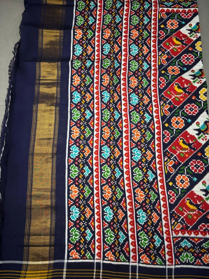 The image shows premium handwoven double ikat patola silk sari/ saree from Patan, Gujarat , perfect for MetGala.
